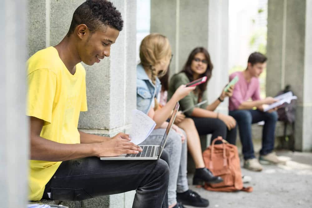 Prepare For Your College Campus Tour Young Man Working on his Laptop